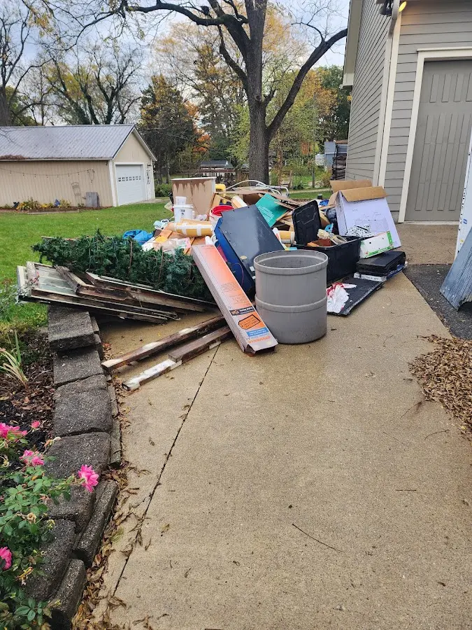 Dumpster being loaded with debris for Roofing Dumpster Rental in Central Falls